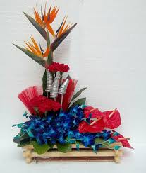 Basket with anthuriums blue orchids and bird of paradise