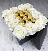 20 White Roses with 16 Ferrero rocher chocolates in the middle in a black box