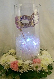 Masque for Masquerade party theme with LED lights encircled with white and pink flowers
